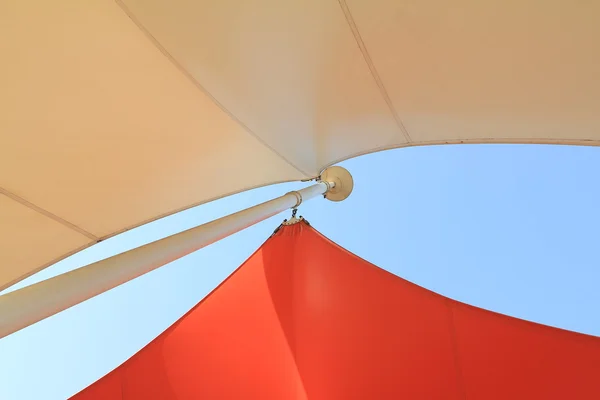 Overhead awnings on a pole against blue sky — Stock Photo, Image