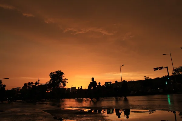 Silhouette of on orange sunset's background — Stock Photo, Image