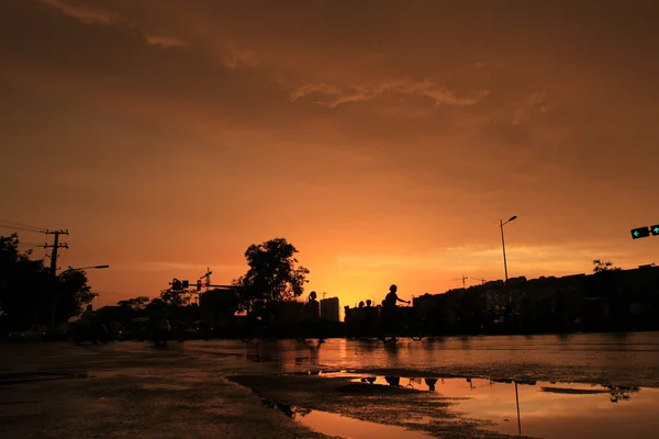 Silhouette of on orange sunset's background — Stock Photo, Image