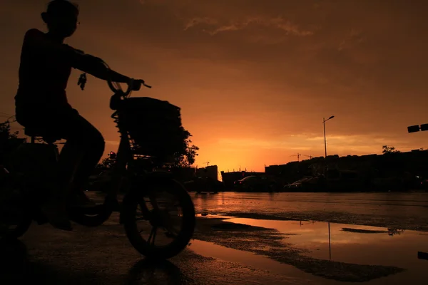 Silhouette of on orange sunset's background — Stock Photo, Image