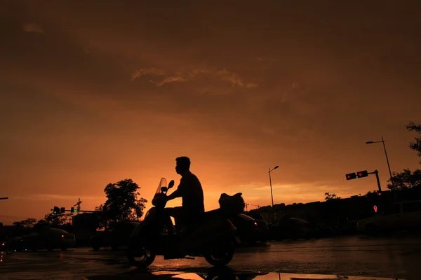 Silhouette of on orange sunset's background — Stock Photo, Image