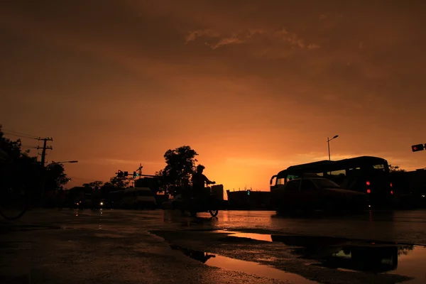 Silhouette of on orange sunset's background — Stock Photo, Image