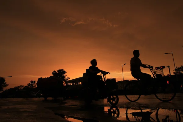 Silhouette of on orange sunset's background — Stock Photo, Image