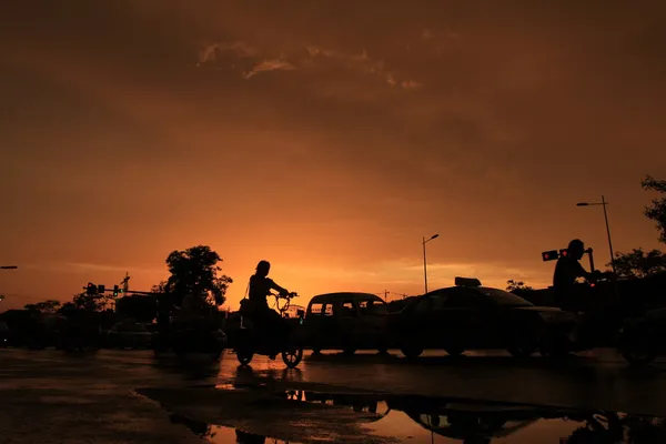 Silhouette of on orange sunset's background — Stock Photo, Image