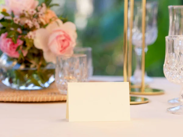 Mockup white blank space card, for Name place, Folded, greeting, invitation on wedding table setting background. with clipping path