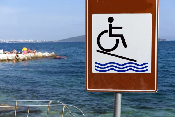 Wheelchair access sign on beach in Croatia
