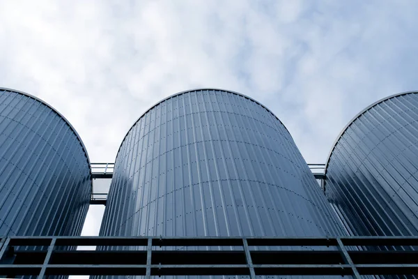 three brewery silos or tanks typically use for storing barley or fermeted beer