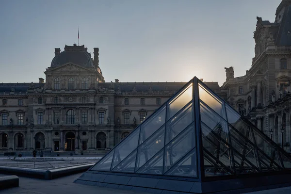 日の出に有名なルーブル美術館とガラスのピラミッドをご覧ください 世界で最も訪問された博物館とパリ フランスの主要な観光スポットの1つ — ストック写真