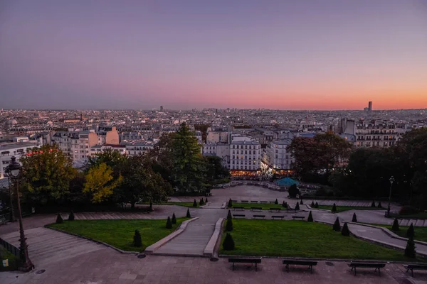 Young People Enjoying the Skyline of the City at Sunset Dusk in Montmartre Hill - Paris, France