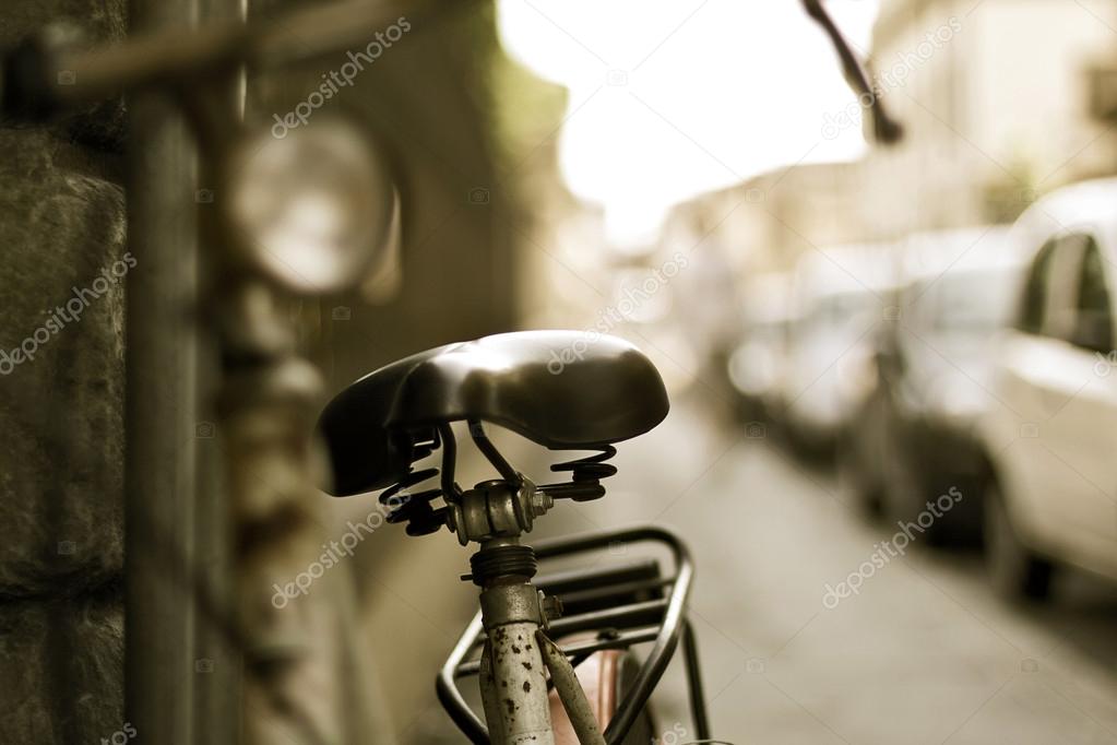 Vintage Bicycle leaning on a wall in italian street, Italy, Florence