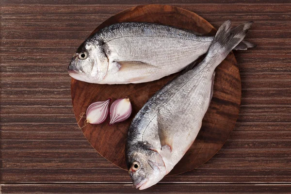 Fish on wooden chopping board. — Stock Photo, Image