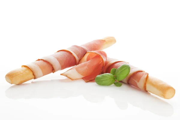 Grissini bread and prosciutto ham. — Stock Photo, Image