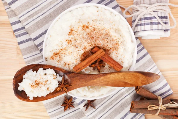 Rice pudding with wooden spoon. — Stock Photo, Image