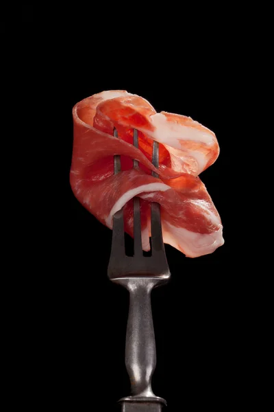 Delicious ham slice on old fork. — Stock Photo, Image