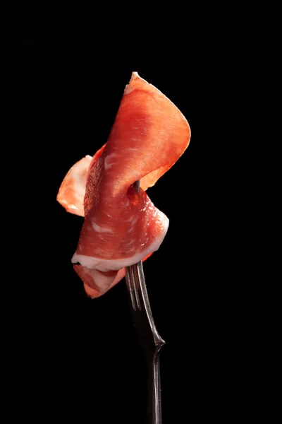 Parma ham on fork isolated. — Stock Photo, Image