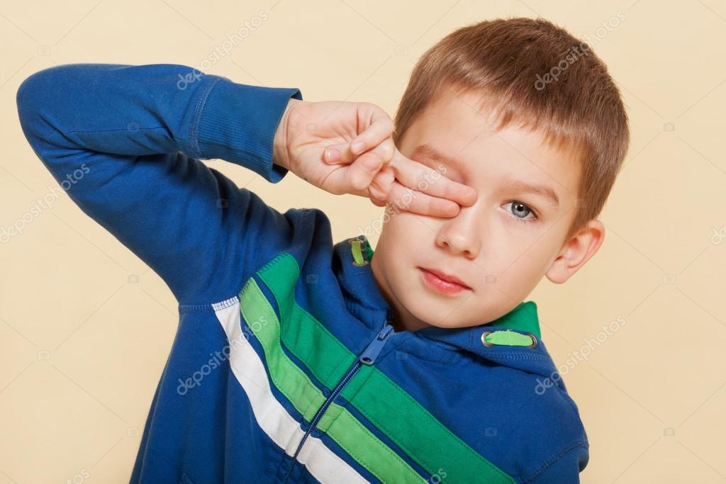 Young boy covering his eye. Stock Photo by ©eskymaks 27176309