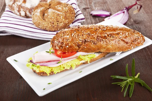 Wholegrain baguette on white tray. — Stock Photo, Image