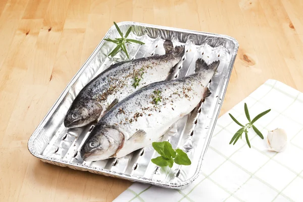 Fish on grilling tray ready for barbecue. — Stock Photo, Image