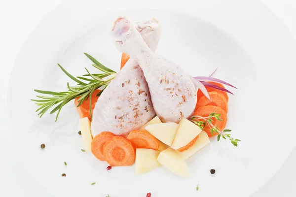 Gambe di pollo su piatto bianco isolato . — Foto Stock