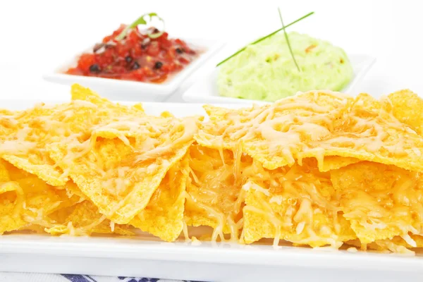 Delicious nachos baked with cheese. — Stock Photo, Image