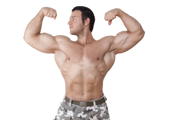 Bodybuilder posiert isoliert. — Stockfoto