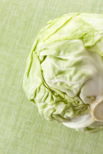 Green cabbage isolated on green. — Stock Photo, Image