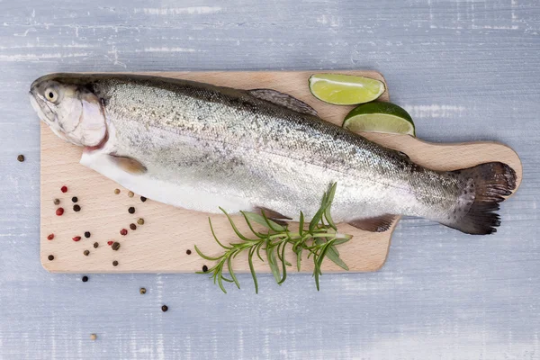 Freh trout on kitchen board. — Stock Photo, Image