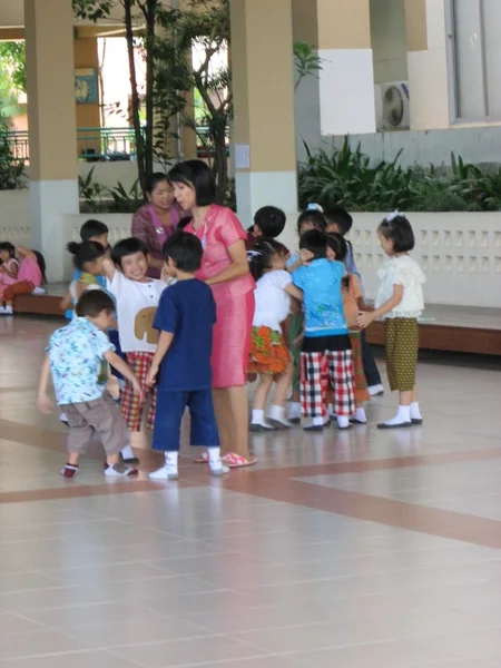 Muchos niños y profesor de jugar juntos en la escuela —  Fotos de Stock