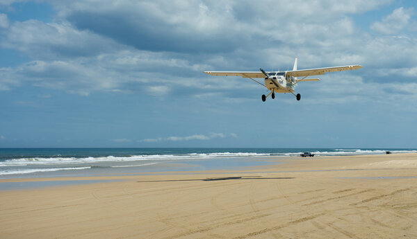 Plane flying over beach