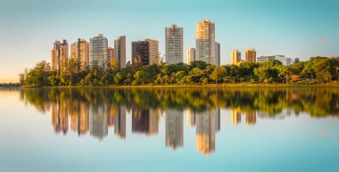 View of Lake Igap in the city of Londrina in Brazil with modern buildings in the background. clipart