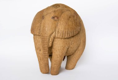 A souvenir figurine of an elephant made of coconut on an isolated white background.