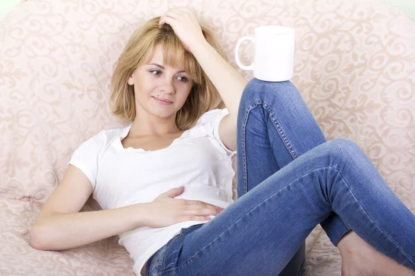 Sweet girl with a white cup in hand. — Stock Photo, Image