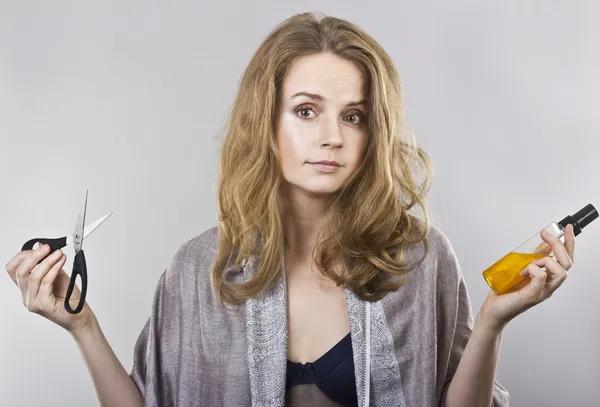 Beautiful curly blonde takes care of her hair — Stock Photo, Image