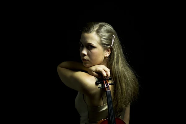 Lady with red violin in hand  in the dark — Stock Photo, Image