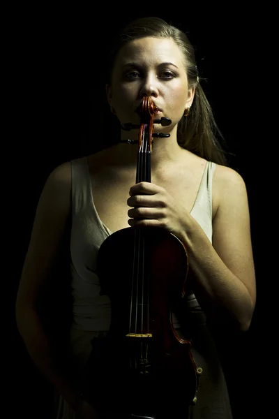 Lady with red violin in hand  in the dark — Stock Photo, Image