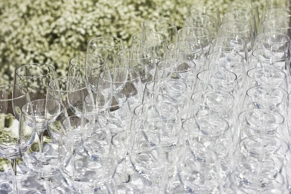 Wedding glasses on the white silk tablecloth, on the street. sunny weather. wedding preparations.