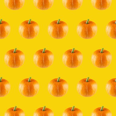 Sarı arka planda turuncu balkabaklarının pürüzsüz deseni.