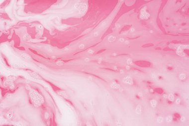 Pembe su ve köpüğün soyut arkaplanı.