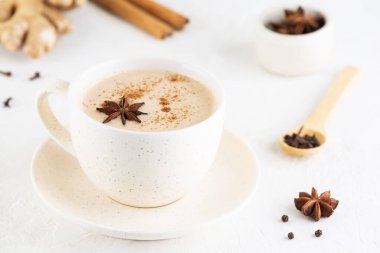 Masala tea with coconut milk and spices in a mug on the table. Lactose free, vegan.