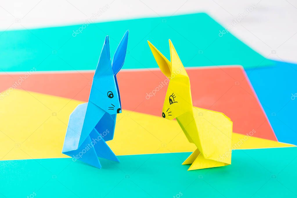 Multi-colored paper rabbits on the table.
