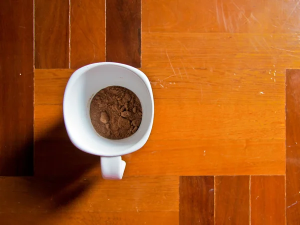 Top view cup on wood floor — Stock Photo, Image