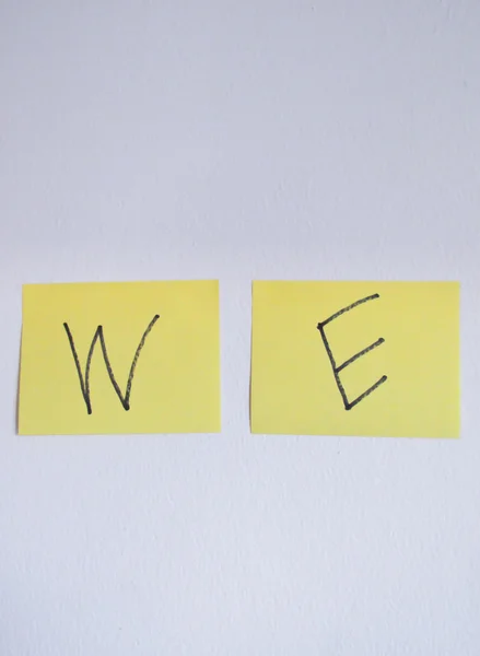 We word on post it at white concrete wall — Stock Photo, Image