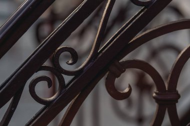 old rusty wrought iron locks and trim forged by a blacksmith on an old wooden gate