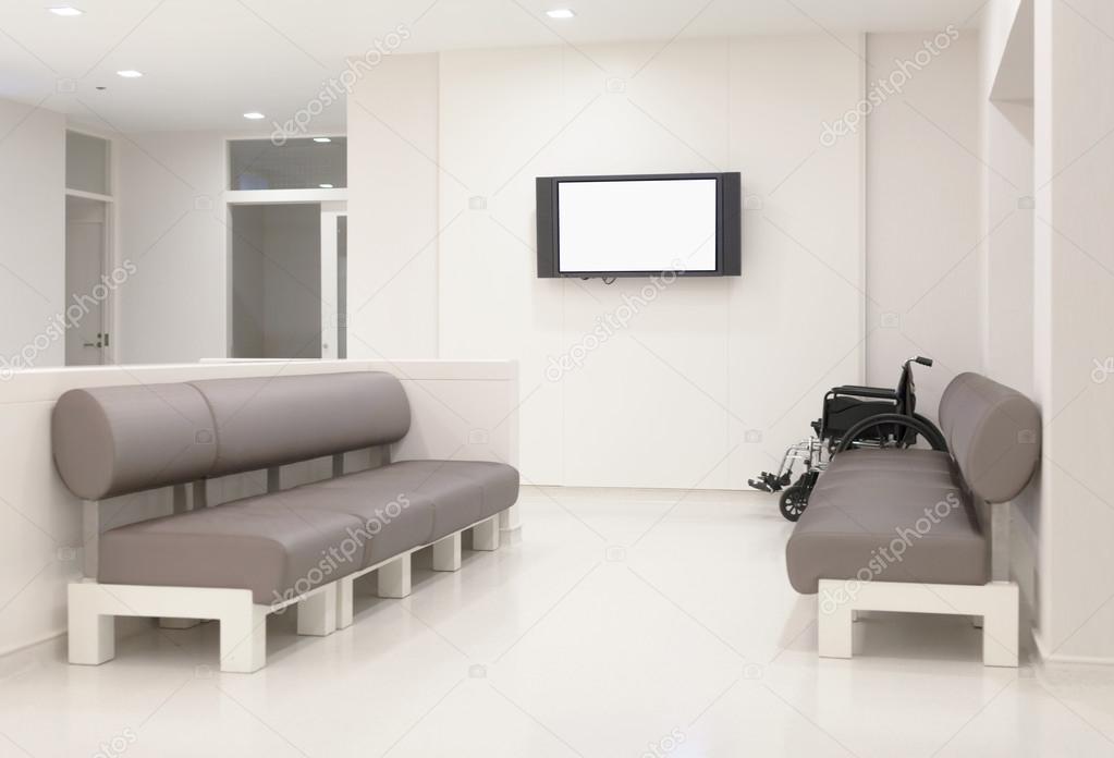 Hospital waiting room with empty chairs.