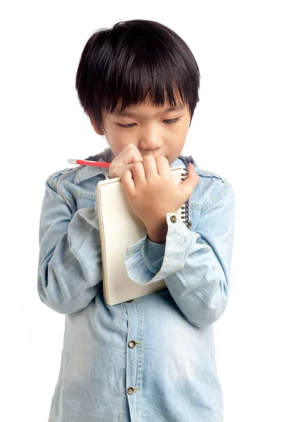 Aziatisch jongen schrijven op notebook — Stockfoto