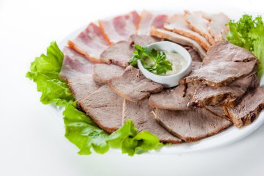 Farklı füme jambon ve domuz pastırması beyaz zemin üzerine marul ile