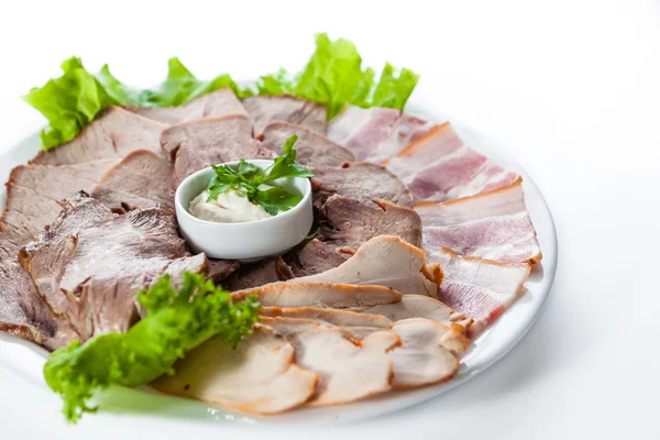 Sliced bacon and ham with lettuce on white plate — Stock Photo, Image