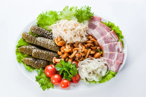 Assorted snacks. pickles, tomatoes, bacon and mushrooms — Stock Photo, Image