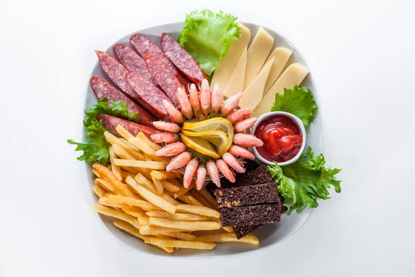 Assorted snacks: cheese, salami, shrimp, french fries — Stock Photo, Image