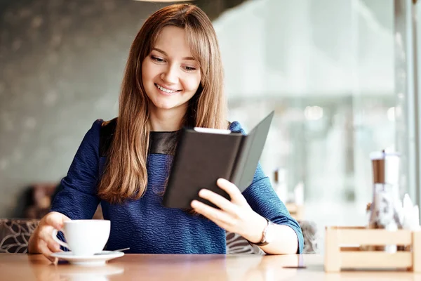 Young Woman Cafe Reading Ebook Drinking Coffee Royalty Free Stock Photos